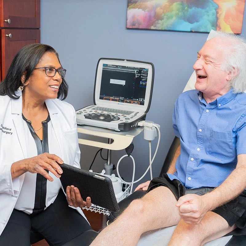 Dr.-Alford-with-a-patient-discussing-treatment-options Dr.-Alford-with-a-patient-discussing-treatment-options
